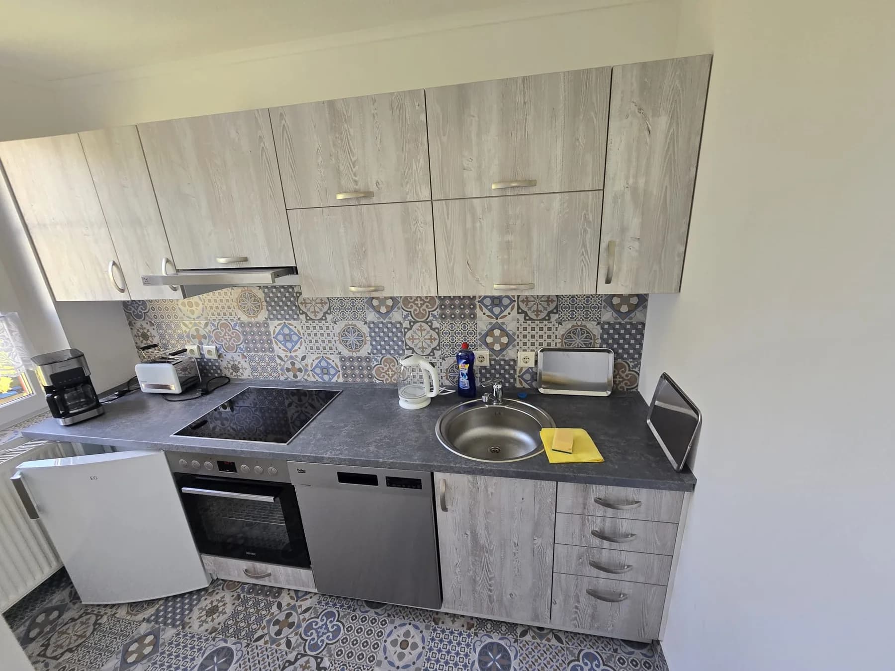 Küchenzeile mit Herd, Spülmaschine und Kühlschrank